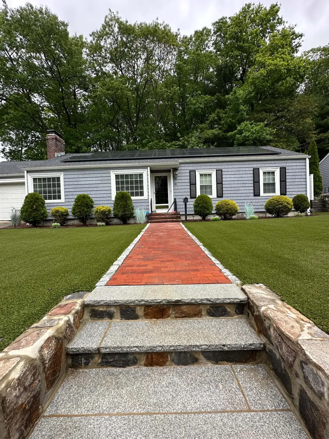 Artificial front lawn and brick walkway