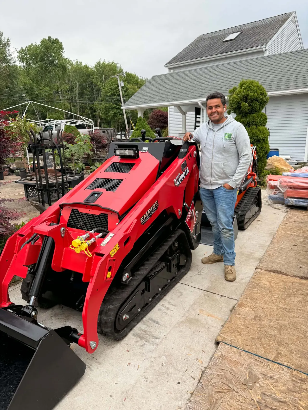 FW team member wearing company uniform beside construction equipment