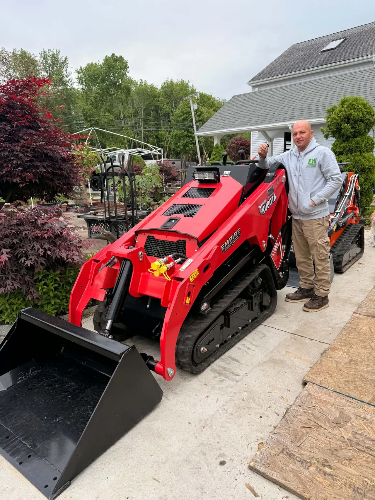 FW team member beside company construction equipment