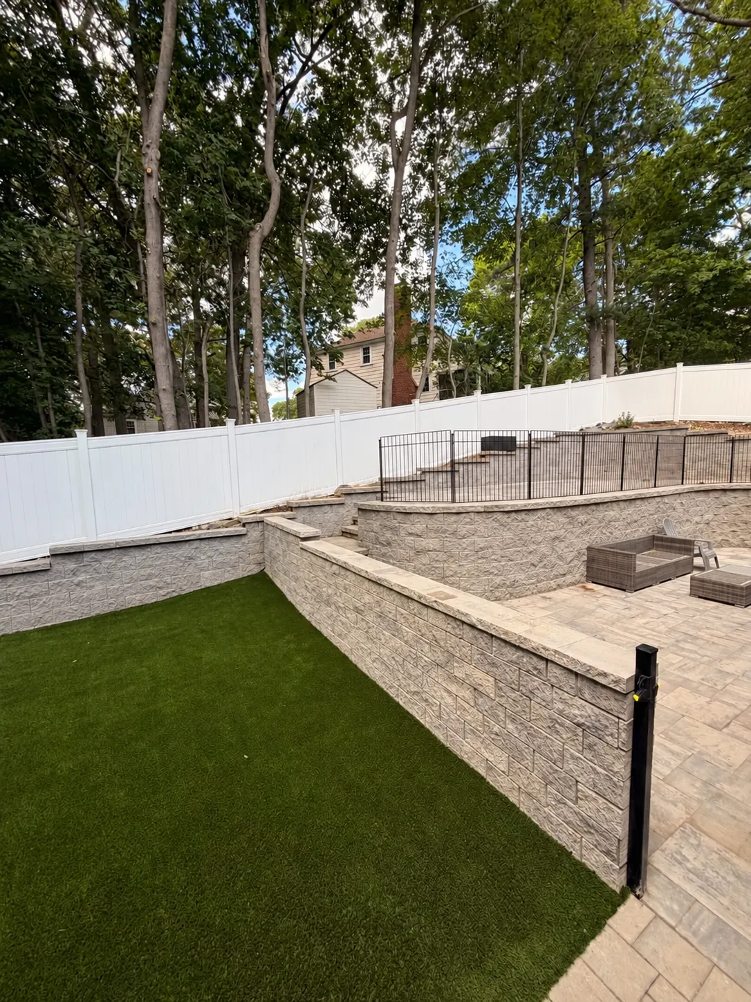 Same property with artificial lawn, paver patio and landscape walls