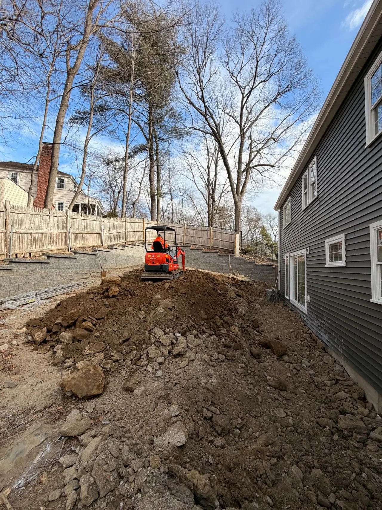 Backyard excavation and site work before the patio and artificial lawn