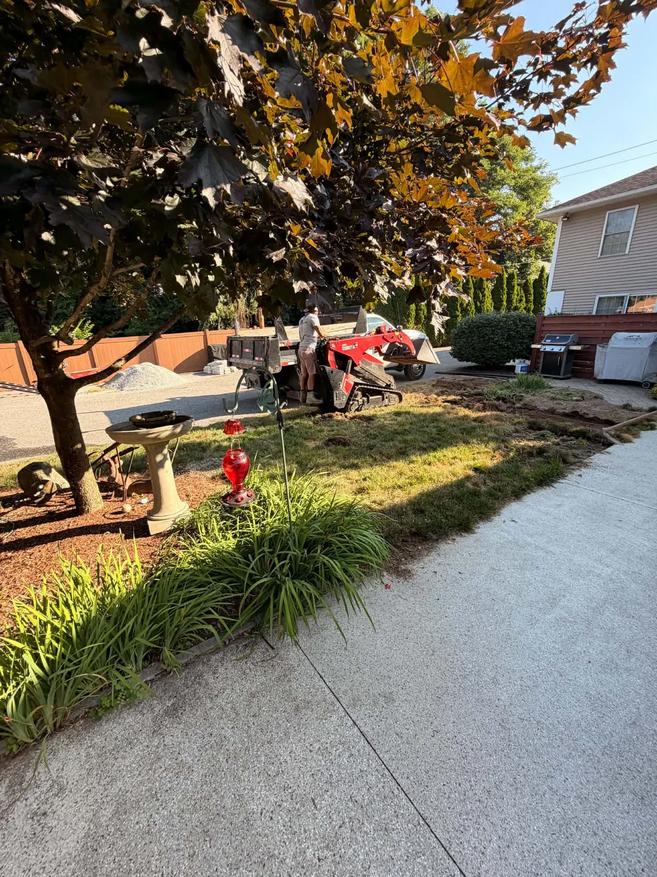 Equipment removing an existing lawn during preparation